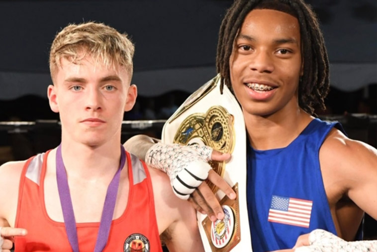 Two boxers, one holding a winner's belt